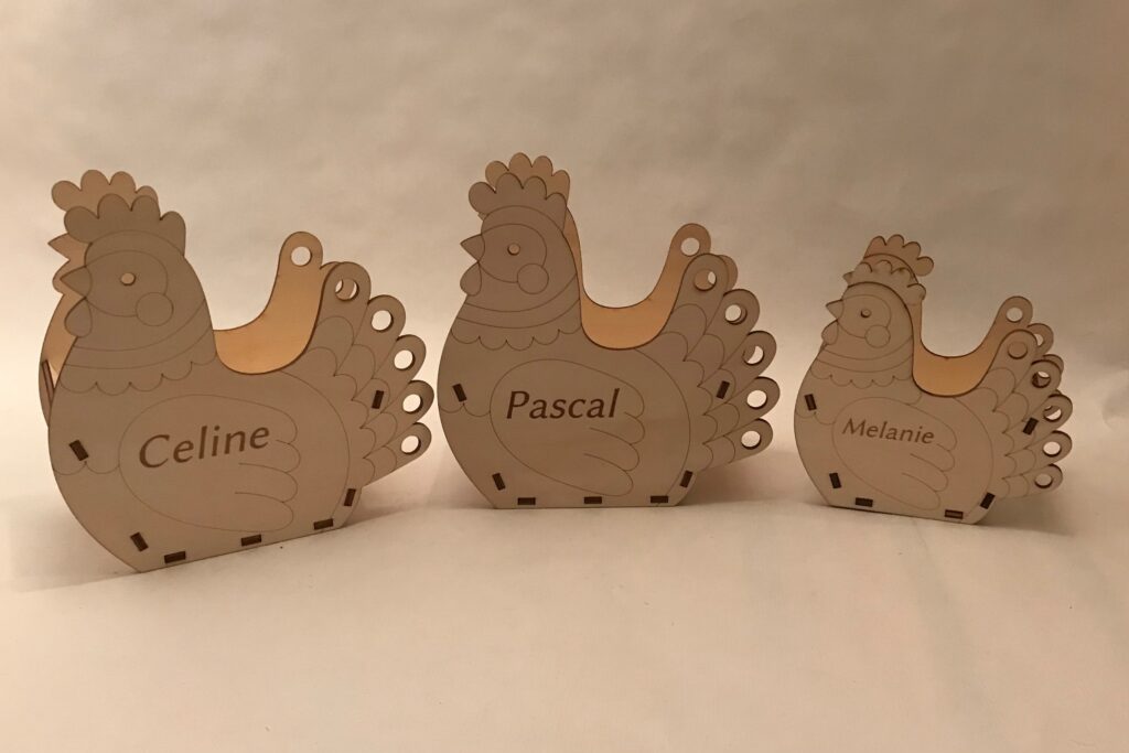Holzhühner mit personalisierten Gravuren Celine, Pascal und Melanie, geeignet als individuelle Geschenke.