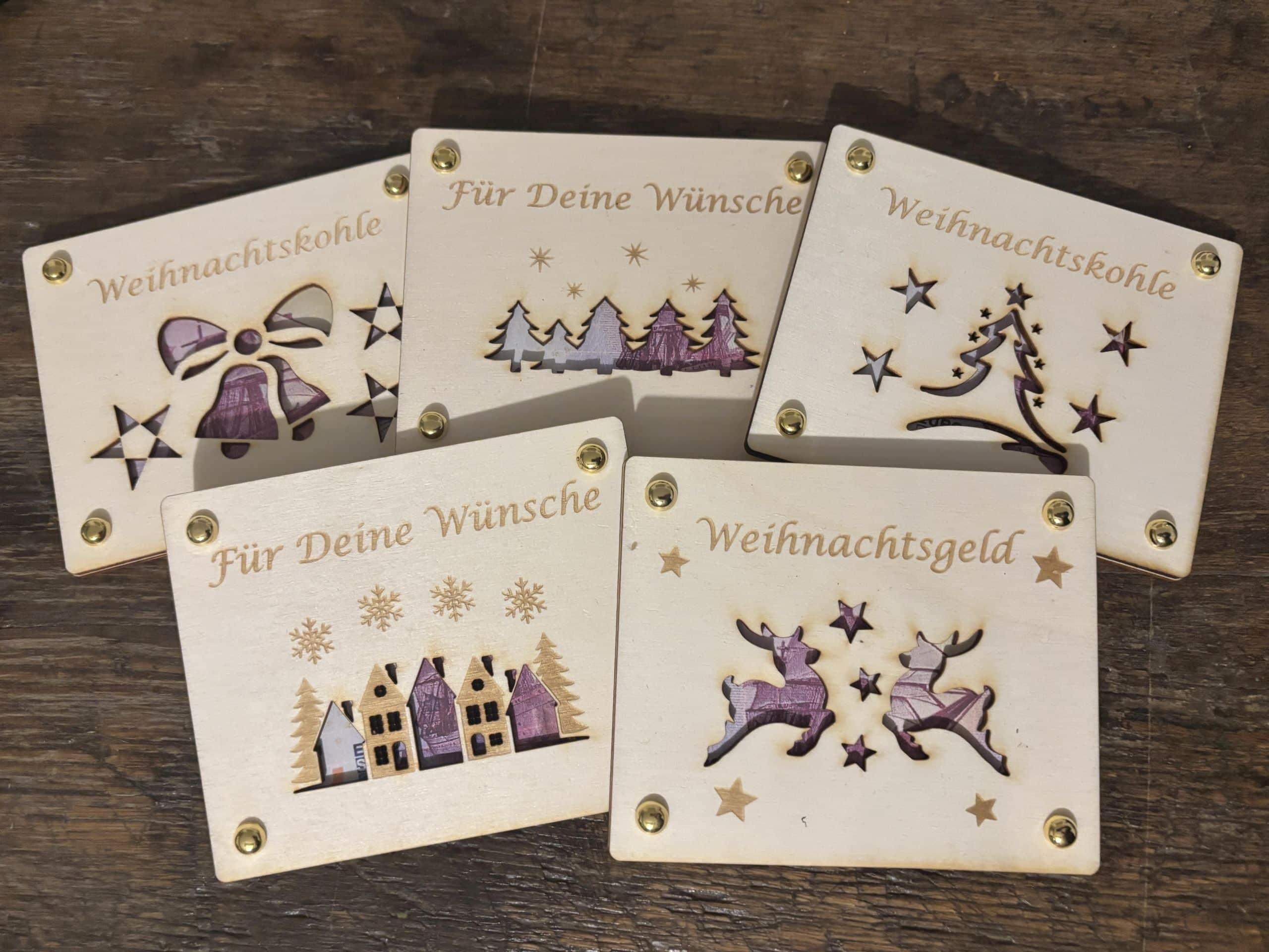 Lasergravierte Weihnachtskarten mit festlichen Motiven und Aufschriften wie Für Deine Wünsche und Weihnachtsgeld.